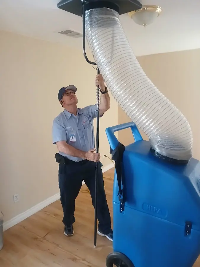 Furnace Tune-Up technician using HEPA equipment in Charleston